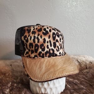 Ball cap with hand-sewn leather patch on brim